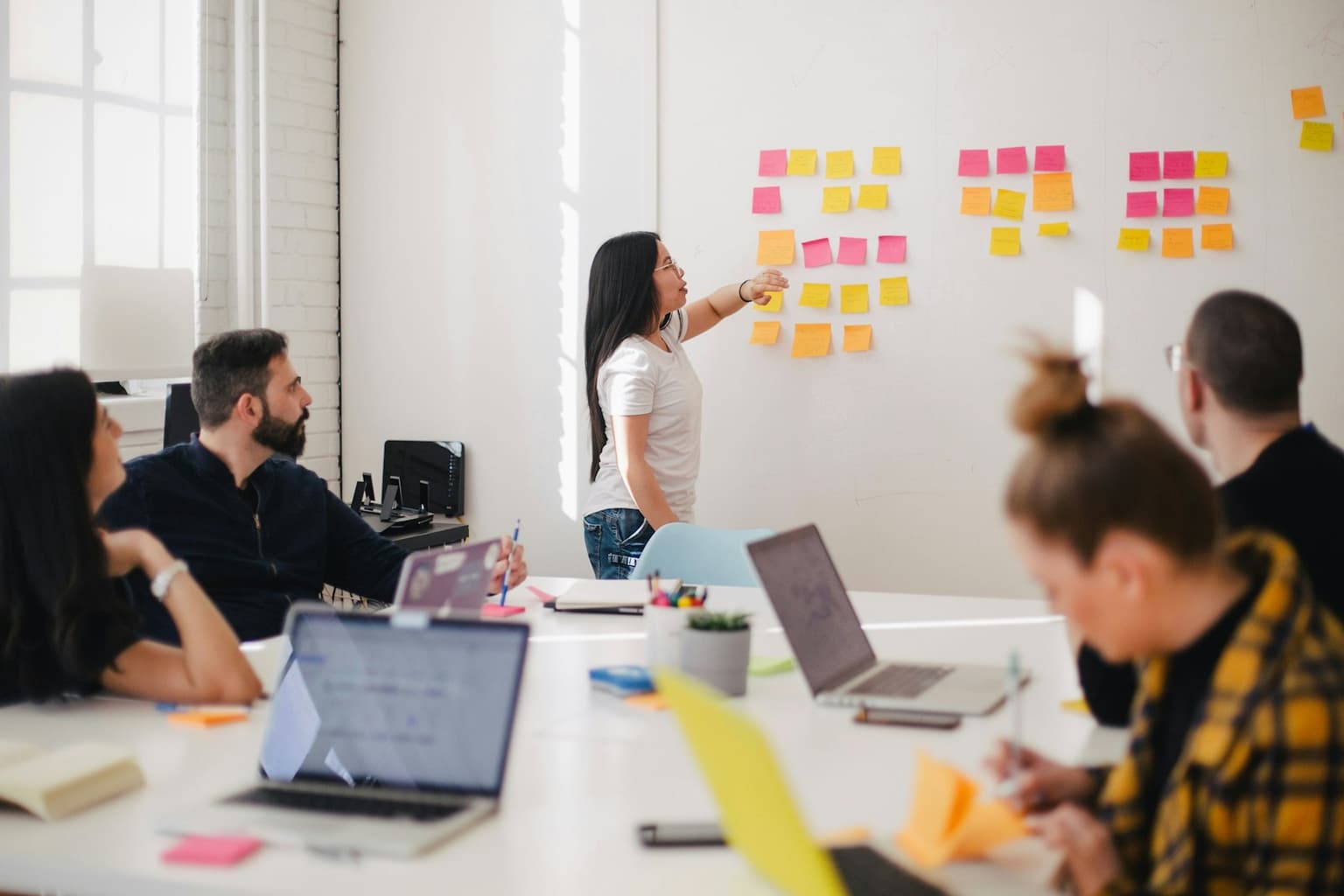 A small team mapping a workflow on a wall during a working session